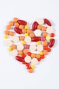 Heart shaped medical pills and capsules on white background, health care concept Royalty Free Stock Photo