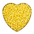 Heart shaped metal box full of corn kernels Royalty Free Stock Photo