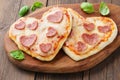 Heart shaped mini pizza with pepperoni, tomatoes and mozzarella Royalty Free Stock Photo