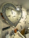 Heart shaped mirror in a bathroom.