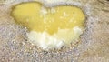 Heart-Shaped Mud Puddle on Gravel Path with Tree Reflections Royalty Free Stock Photo
