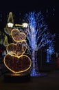 heart-shaped New Year`s decoration and a decorated tree that glows at night