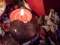 the heart shaped object has a lit candle inside of it Royalty Free Stock Photo