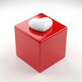 A heart-shaped object sits atop a glossy red cube against a plain background. isolated on white background Royalty Free Stock Photo