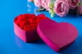 Heart shaped open gift box on blue background Royalty Free Stock Photo