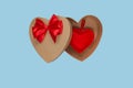Heart shaped open gift box with a red bow on a blue background with a heart inside. Isolate. Valentine`s Day Gift Royalty Free Stock Photo