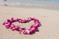 Heart shaped orchid flower garland white sea sand beach Royalty Free Stock Photo