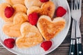 Heart shaped pancakes with raspberries and honey for St. Valentine`s Day