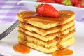 Heart-shaped pancakes with syrup and strawberry