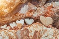 Heart shaped pebble standing on a lush lava rock background. Romantic background, Valentines day concept. Royalty Free Stock Photo