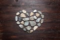 A heart shaped pebble stones on a old wood Royalty Free Stock Photo