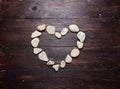 A heart shaped pebble stones on a old wood Royalty Free Stock Photo