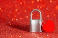 Heart shaped pendant attached to a padlock on red Royalty Free Stock Photo