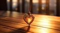 Heart-shaped pendant on a rustic wooden table, vintage golden gift nostalgic lighting Royalty Free Stock Photo