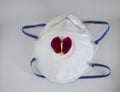 A heart-shaped petal on a medical mask