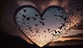 a heart shaped picture with a flock of birds flying in the sky above it at sunset or dawn with a flo Royalty Free Stock Photo