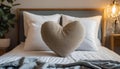 Heart-shaped pillow on top of bed, Soft and cozy Royalty Free Stock Photo