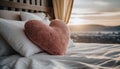 Heart-shaped pillow on top of bed, Soft and cozy. Minimalistic bedroom Royalty Free Stock Photo