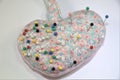 Heart-shaped Pin cushion with pins on white Royalty Free Stock Photo