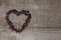 Heart shaped pine nuts on wooden background Royalty Free Stock Photo