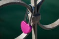 Heart shaped pink love padlock on bridge rail Royalty Free Stock Photo