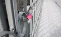 Heart shaped pink love padlock on the steel bridge rail Royalty Free Stock Photo