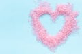 heart shaped Pink sea salt frame on blue background Royalty Free Stock Photo