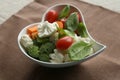 Heart shaped plate with fresh vegetables.