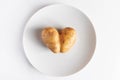 Heart shaped potatoes on a white plate. Valentine\'s day concept. Ugly food