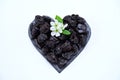 heart-shaped prunes and plum blossom on a white background Royalty Free Stock Photo