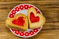 Heart shaped puff cookies with jam on wooden table. Top view. Dessert on Valentine`s Day