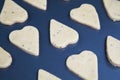 Heart shaped raw dough cookies with caraway on metal baking tray