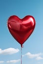 Heart shaped red air balloon flying in blue sky. Symbol of love. St Valentine\'s day concept Royalty Free Stock Photo