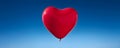 Heart shaped red air balloon flying in blue sky. Symbol of love. St Valentine\'s day concept Royalty Free Stock Photo