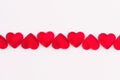 Heart shaped red jelly sweets in a row on white background. Copy space. Royalty Free Stock Photo
