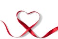 Heart shaped red ribbon for Valentine`s day celebration on an isolated white background Royalty Free Stock Photo