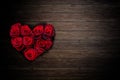 Heart shaped red roses bouquet on rustic wooden background Royalty Free Stock Photo