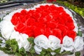 Heart shaped red and white roses wedding flower bouquet in front of the newly wed couple`s car. Sign and symbol of love, wedding Royalty Free Stock Photo