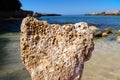 A heart shaped rock, eroded limestone with sea in the background - summer holiday vacations concept - Italy, Apulia, Monopoli
