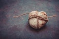 Heart shaped rock pebble tied with twine on dark blue purple stone background, conceptual, relationship, valentine Royalty Free Stock Photo