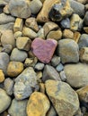 Heart shaped rock on pile of pebble rocks