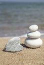 Heart shaped rock and stack of pebble stones on balance on a beach Royalty Free Stock Photo