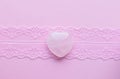 Heart shaped rose quartz crystals on pink lace. Semi-precious minerals are a love talisman for women