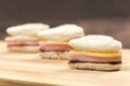 Heart shaped sandwich recipe, ingredients with sauces on a wooden board. Close up, selective focus
