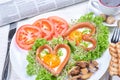 Heart shaped sausages with fried eggs Royalty Free Stock Photo