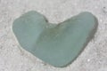 Heart Shaped Sea Glass on a White Sand Beach