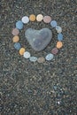 Heart shaped sea stone pebble on sandy beach Royalty Free Stock Photo