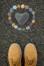 Heart shaped sea stone pebble on sandy beach Royalty Free Stock Photo