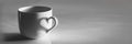 Heart shaped shadow on a coffee cup, black and white Royalty Free Stock Photo