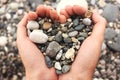 Heart shaped small pebbles in female hands Royalty Free Stock Photo